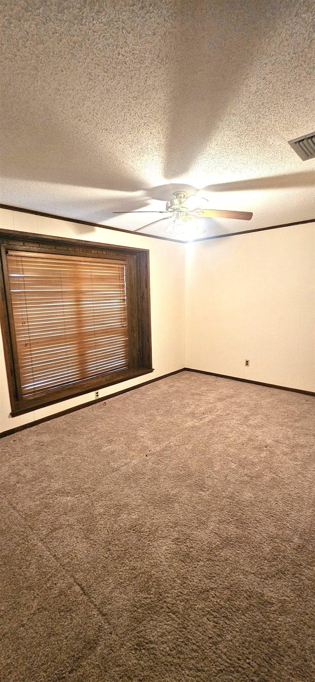 unfurnished bedroom featuring a textured ceiling, carpet flooring, and ceiling fan