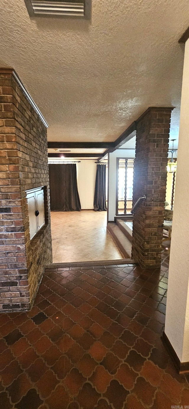 hallway featuring a textured ceiling