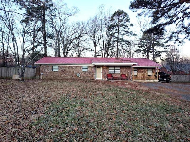 single story home with brick siding and fence