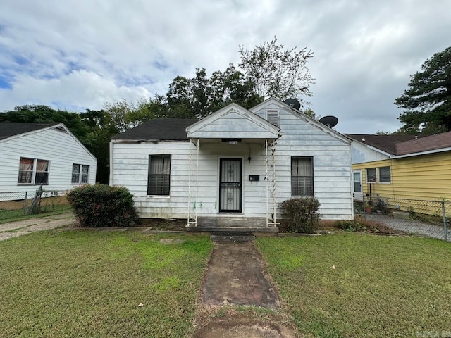 bungalow-style house with a front lawn