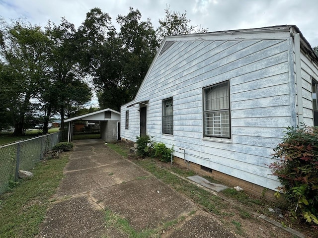 view of home's exterior featuring a carport