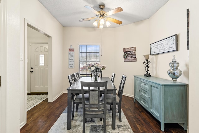 dining area with a textured ceiling, dark hardwood / wood-style floors, and ceiling fan