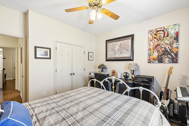 bedroom with a closet, hardwood / wood-style floors, and ceiling fan