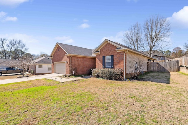 ranch-style home featuring a garage and a front yard