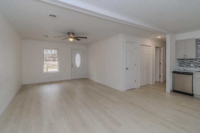 interior space featuring light hardwood / wood-style flooring, ceiling fan, and a textured ceiling