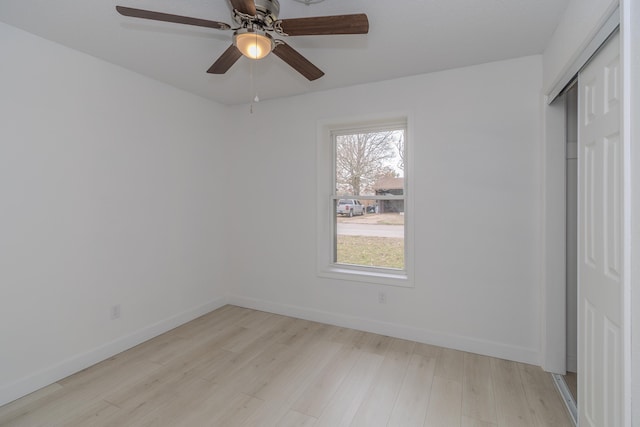 unfurnished bedroom with light wood-type flooring, a closet, and ceiling fan