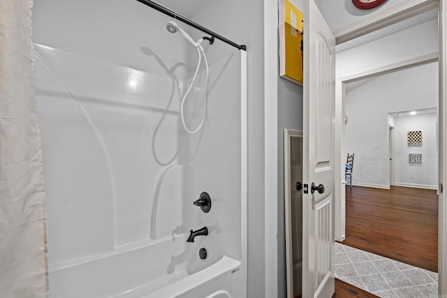 bathroom with shower / bath combo and hardwood / wood-style flooring