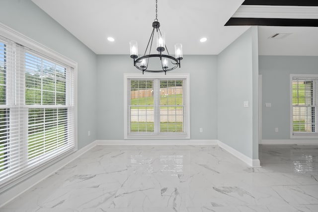 unfurnished dining area with plenty of natural light and an inviting chandelier