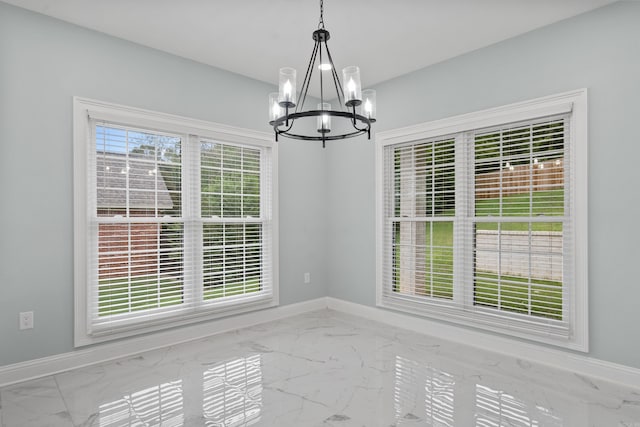 unfurnished dining area featuring a notable chandelier and plenty of natural light