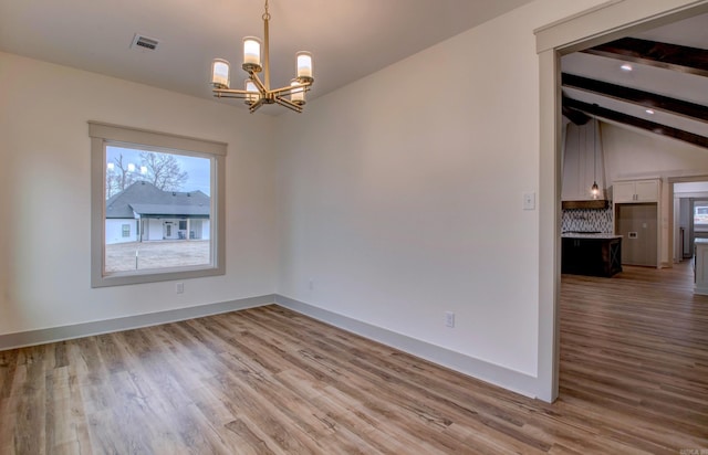 unfurnished room featuring vaulted ceiling with beams, a chandelier, and light hardwood / wood-style flooring