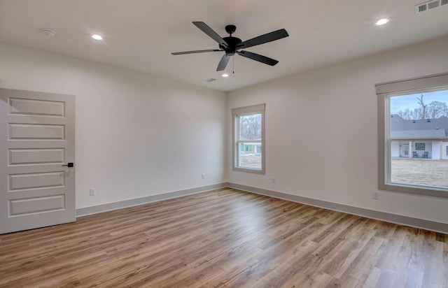 empty room with light wood-type flooring and ceiling fan