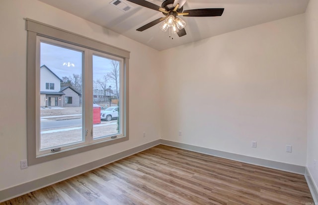 unfurnished room with ceiling fan and light wood-type flooring