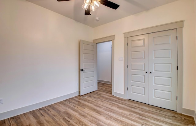 unfurnished bedroom with light hardwood / wood-style floors, a closet, and ceiling fan