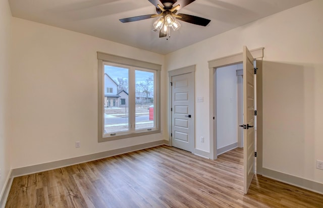 unfurnished bedroom featuring light hardwood / wood-style flooring and ceiling fan