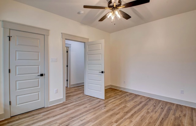 unfurnished bedroom featuring ceiling fan and light wood-type flooring