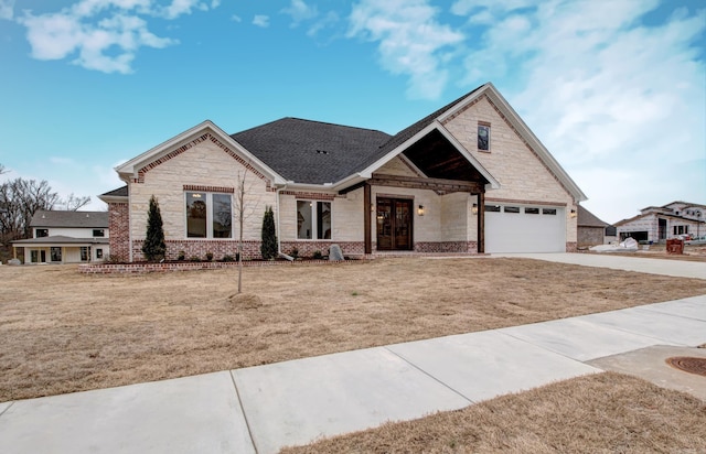 craftsman-style home featuring a garage and a front lawn