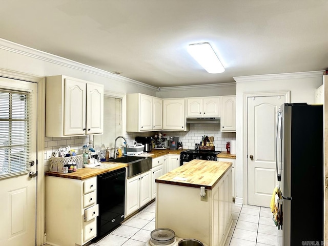 kitchen featuring butcher block countertops, a kitchen island, stainless steel fridge, and dishwasher