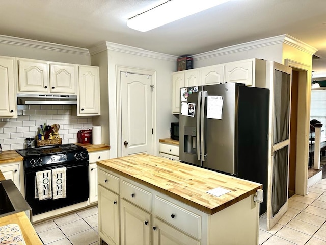 kitchen featuring black appliances, crown molding, light tile patterned flooring, and butcher block counters