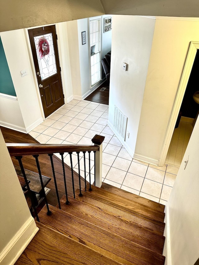 staircase featuring tile patterned flooring