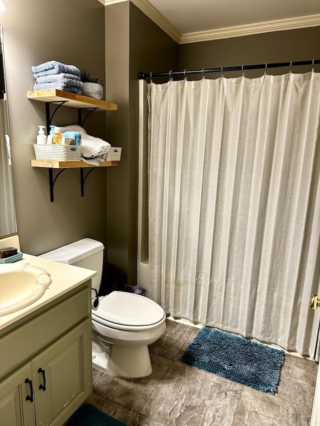 bathroom with ornamental molding, vanity, and toilet