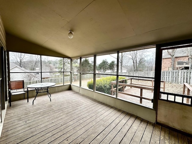 sunroom / solarium featuring lofted ceiling