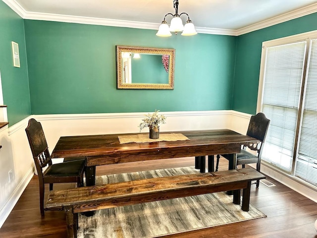 dining area featuring a chandelier, crown molding, and dark hardwood / wood-style floors