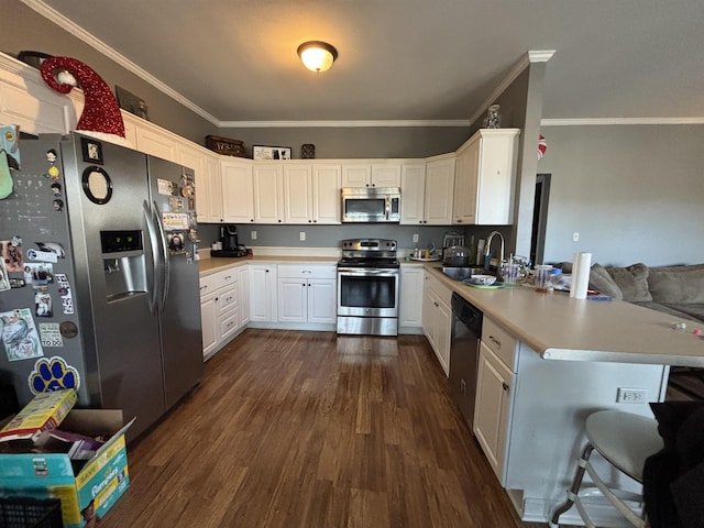 kitchen featuring sink, white cabinetry, stainless steel appliances, and kitchen peninsula