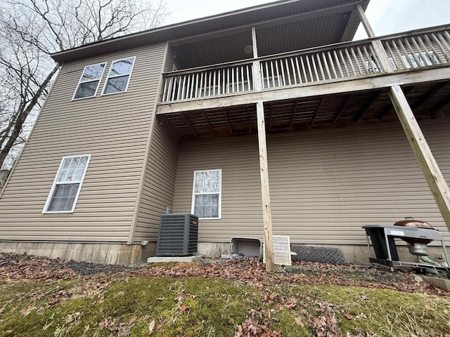 view of home's exterior featuring central air condition unit and a balcony