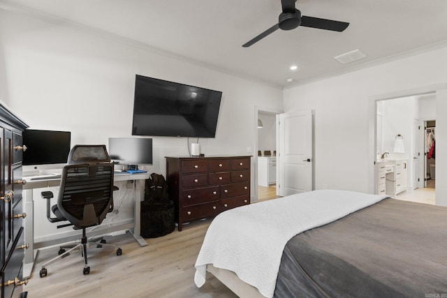 bedroom with ceiling fan, light hardwood / wood-style flooring, and connected bathroom