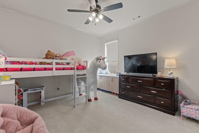 carpeted bedroom featuring ceiling fan and crown molding