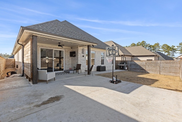 rear view of house featuring ceiling fan and a patio area