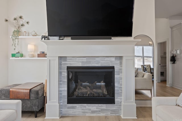 interior details featuring hardwood / wood-style flooring and a fireplace