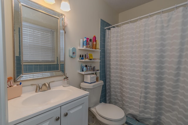 bathroom featuring vanity, curtained shower, and toilet