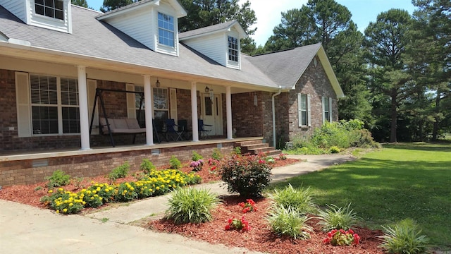 exterior space with a yard and covered porch