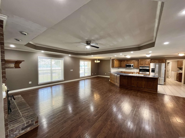 kitchen featuring a tray ceiling, stainless steel appliances, and hardwood / wood-style floors