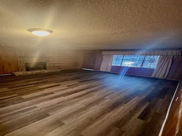 bonus room featuring a textured ceiling and wood finished floors