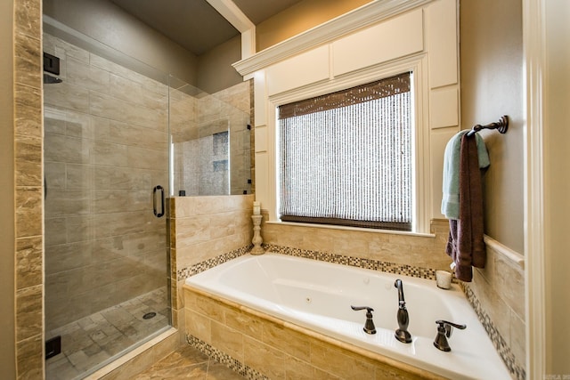 bathroom featuring independent shower and bath