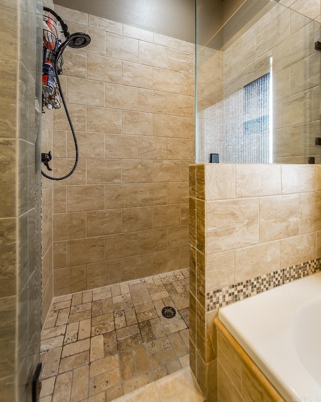 bathroom with a tile shower