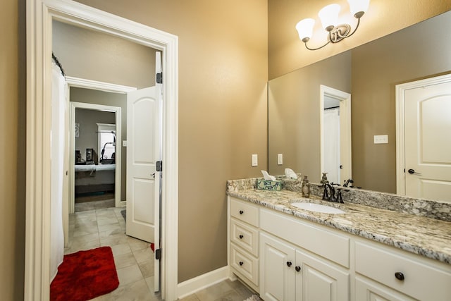 bathroom featuring tile patterned floors, vanity, and an inviting chandelier