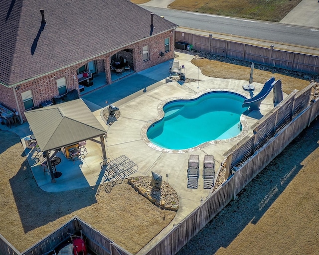 view of pool featuring a patio area, a water slide, and a gazebo