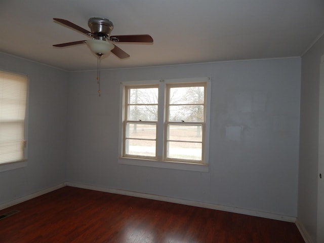 spare room with dark wood-type flooring and ceiling fan