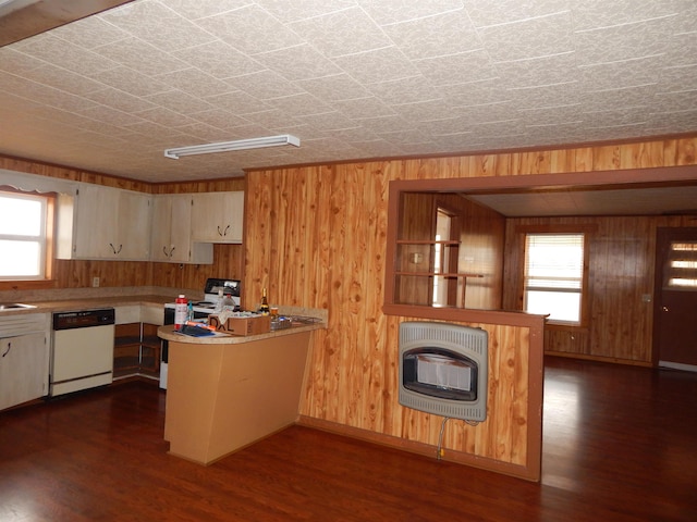 kitchen with heating unit, white appliances, dark hardwood / wood-style flooring, and a wealth of natural light