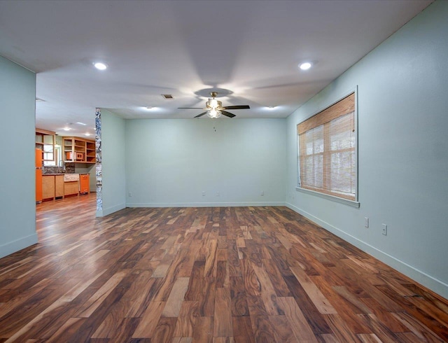 unfurnished room featuring sink, dark hardwood / wood-style floors, and ceiling fan