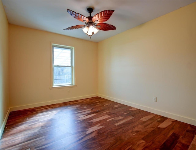 empty room featuring ceiling fan and dark hardwood / wood-style flooring