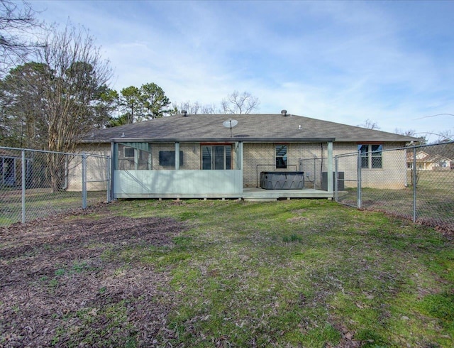 back of property featuring a lawn and a wooden deck