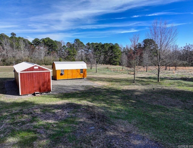 view of yard with a shed and a rural view