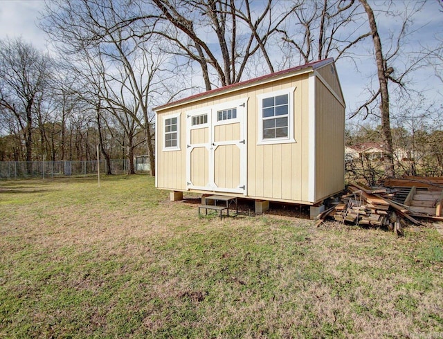 view of outbuilding featuring a yard