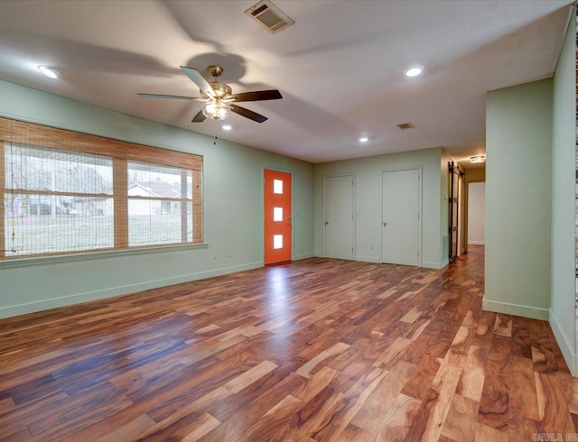 empty room with hardwood / wood-style floors and ceiling fan