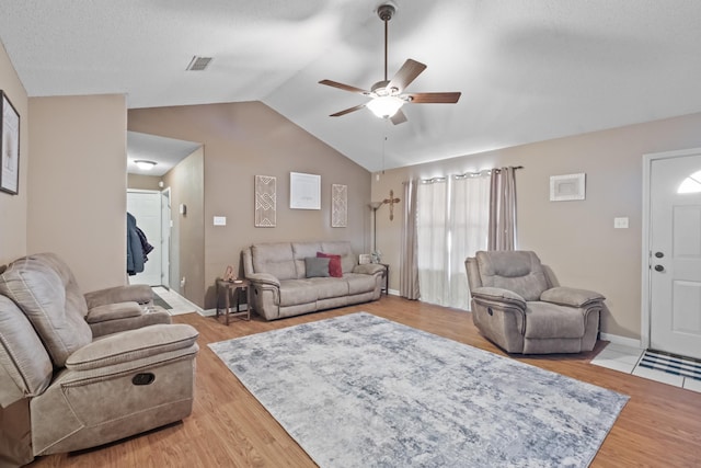 living room featuring vaulted ceiling, ceiling fan, and hardwood / wood-style flooring