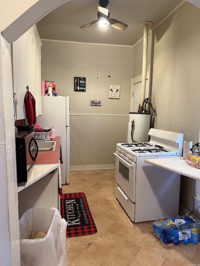 kitchen featuring white range with gas stovetop, ceiling fan, ornamental molding, and sink